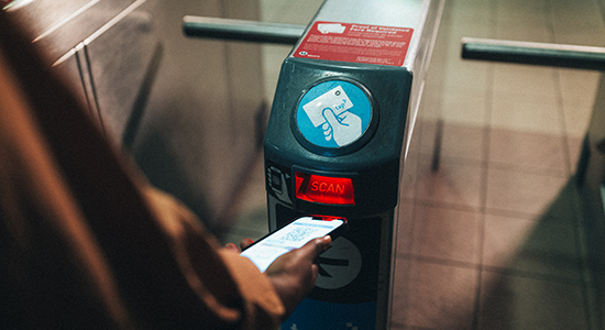 Metrolink customer tapping at Metro gate.